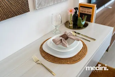 a table with a plate and a napkin on it at Studio - Azizi Riviera 37 in Dubai