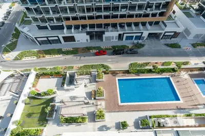 an overhead view of a building with a swimming pool at 12min from Burj Khalifa - Studio - Azizi Riviera in Dubai