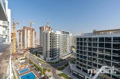 an aerial view of a city with tall buildings at 12min from Burj Khalifa - Studio - Azizi Riviera in Dubai