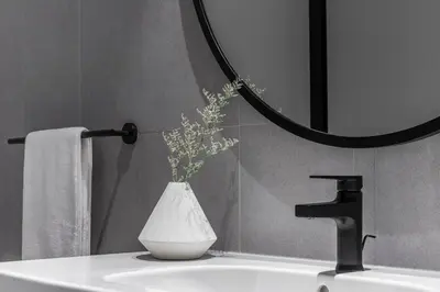 a bathroom sink with a vase with flowers in it at Rare Luxury 1bdr 15 Northside in Dubai
