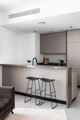 a kitchen with two bar stools and a counter at Rare Luxury 1bdr 15 Northside in Dubai