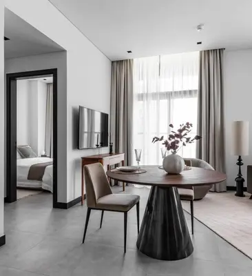 a living room with a table and a bedroom at Rare Luxury 1bdr 15 Northside in Dubai