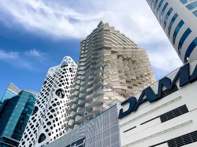 a tall building with aania sign on top of it at Sophisticated Binghatti Canal in Dubai