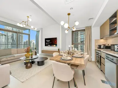 a kitchen and dining room with a table and chairs at 2BR-Downtown Apartment- 10 Min Walk to Dubai Mall in Dubai