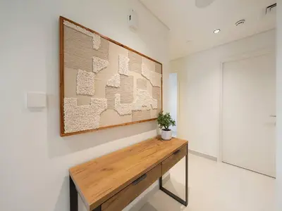 a table in a room with a painting on the wall at 2BR-Downtown Apartment- 10 Min Walk to Dubai Mall in Dubai