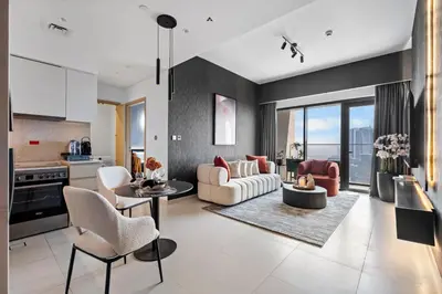 a kitchen and living room with a couch and chairs at Cosmic Sky Suite High floor 1BR- Dubai Mall Access by Maxx Value Homes in Dubai