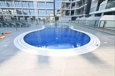 a large pool in the middle of a building at Studio entièrement meublé in Dubai