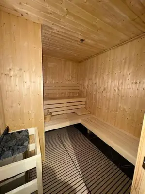 a sauna with wooden walls and benches in a room at Studio entièrement meublé in Dubai