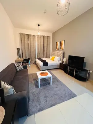 a living room with a couch and a table at Luxury Studio Apartment In Dubai Marina in Dubai