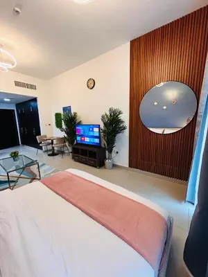 a bedroom with a bed and a tv in a room at Luxury Studio Apartment In Dubai Marina in Dubai