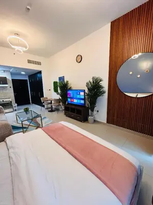 a bedroom with a bed and a living room at Luxury Studio Apartment In Dubai Marina in Dubai