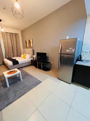 a living room with a refrigerator and a bed at Luxury Studio Apartment In Dubai Marina in Dubai