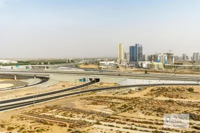 an aerial view of a city with a freeway at Capital Stay - Cozy Studio in Liwan Dubai in Dubai