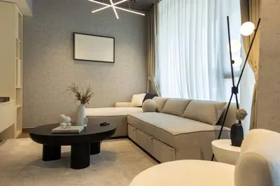 a living room with a couch and a table at WelHome - LOCI Residences in Dubai