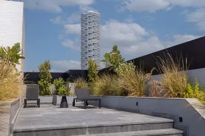 a view of a building with a tower in the background at WelHome - LOCI Residences in Dubai