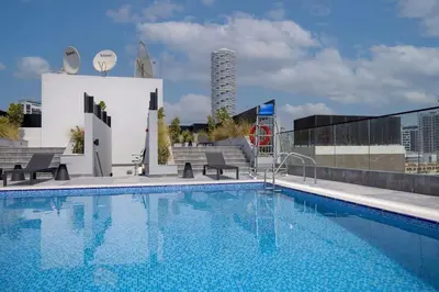 a swimming pool on the roof of a building at WelHome - LOCI Residences in Dubai