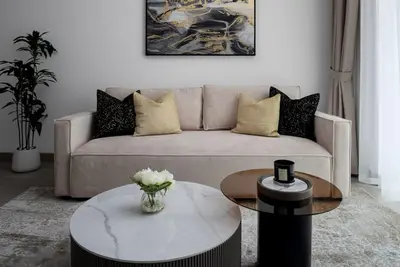 a living room with a couch and a coffee table at Waves - Luxury Meets Comfort, Modern 1BR in JVCs Luma22 in Dubai