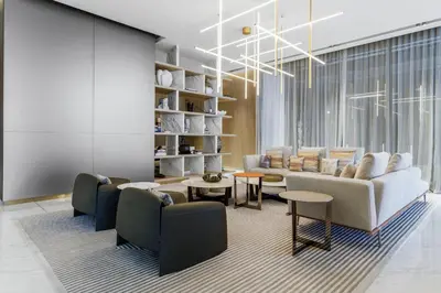 a living room with a couch and chairs at Old Form in Dubai