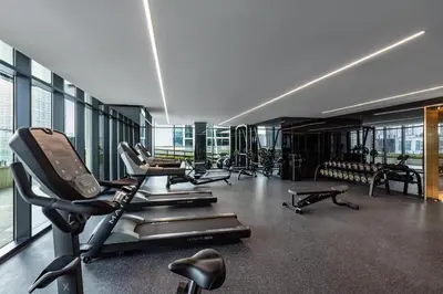 a gym with a bunch of treadmills and machines at Old Form in Dubai