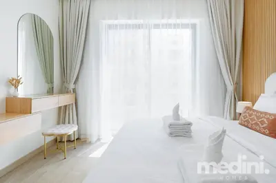 a white bedroom with a bed and a window at 1-Bedroom - in Emaar Creek Harboor in Dubai