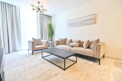 a living room with a couch and a coffee table at Centrally Located 1 Bedroom in District One Meydan in Dubai