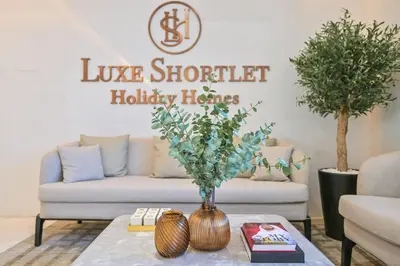 a living room with a couch and a table at Paradise1BR by the Crystal Lagoon in District One Meydan in Dubai