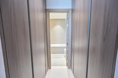 a bathroom with a glass door leading to a toilet at Family-friendly 1 Bedroom in District One Meydan in Dubai