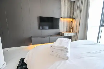 a hotel room with a bed with towels on it at 1 Bedroom in District One Meydan in Dubai