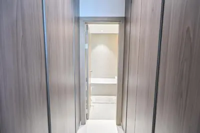 a hallway with a door leading to a bathroom at Luxury and Spacious 1 Bedroom in District One Meydan in Dubai