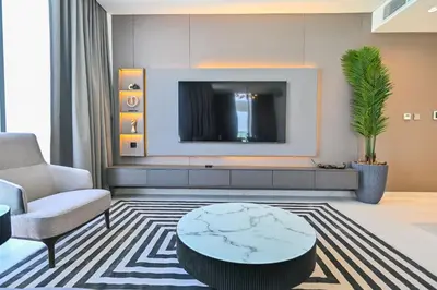 a living room with a tv and a coffee table at Magnificent 2BR in District One Meydan in Dubai