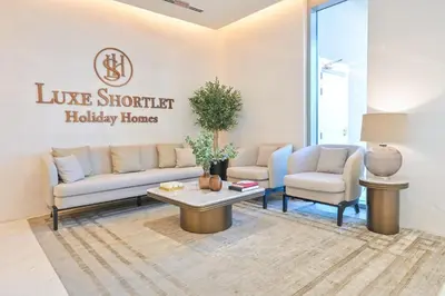 a living room with two couches and a coffee table at Premium 2 Bedroom in District One Meydan in Dubai