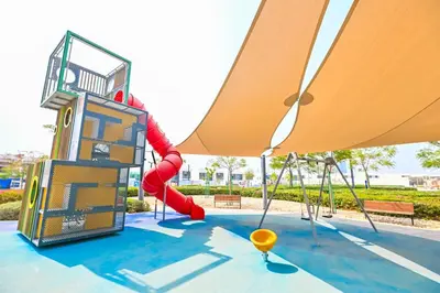 a playground with a slide and a swing set at Premium 2 Bedroom in District One Meydan in Dubai