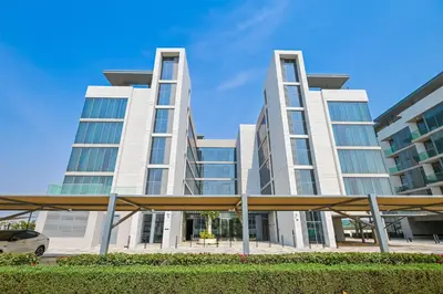 a large white building with a car parked in front of it at Premium 2 Bedroom in District One Meydan in Dubai