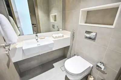 a bathroom with a sink and a toilet at 1BR Haven with Lagoon Serenity in District One Meydan in Dubai
