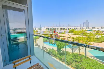 a balcony with a view of a pool at 1BR Haven with Lagoon Serenity in District One Meydan in Dubai