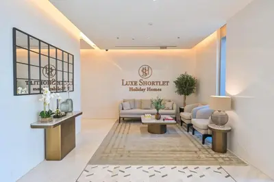 a waiting room with a couch and a table at Unique 2 Bedroom in District One Meydan in Dubai