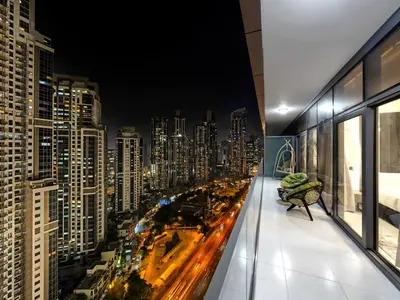 a room with a view of a city at night at Luxury Apartments at Paramount Midtown by Dale Lee in Dubai