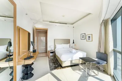 a bedroom with a bed and a desk and a table at 3 Bed in DAMAC Paramount by PK Holidays in Dubai