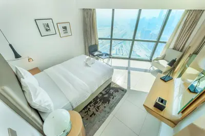 a hotel room with a bed and a large window at 3 Bed in DAMAC Paramount by PK Holidays in Dubai