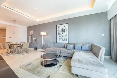a living room with a couch and a table at 3 Bed in DAMAC Paramount by PK Holidays in Dubai