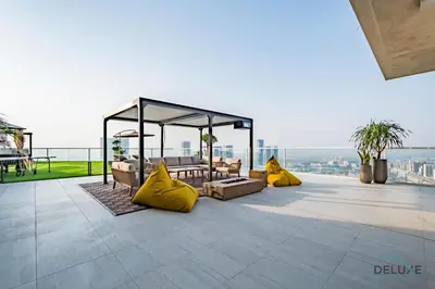a patio with a gazebo and yellow pillows at Spectacular 4BR Penthouse with Assistant Room in Hameni Tower, JVC by Deluxe Holiday Homes in Dubai