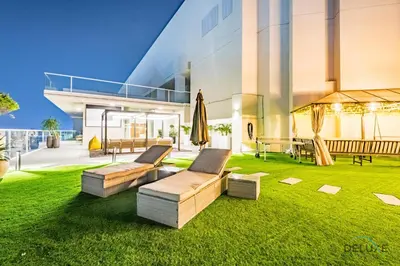 a house with two couches on the lawn at Spectacular 4BR Penthouse with Assistant Room in Hameni Tower, JVC by Deluxe Holiday Homes in Dubai