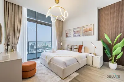 a bedroom with a large bed and a large window at Spectacular 4BR Penthouse with Assistant Room in Hameni Tower, JVC by Deluxe Holiday Homes in Dubai