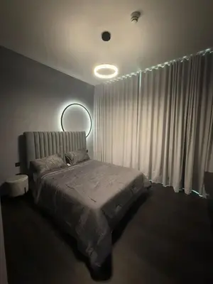 a bedroom with a bed and a window with curtains at Luxury 2BR Close to Sheikh Zayed Rd, Prime Location, Burj View Opposite Metro in Dubai