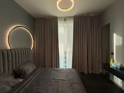 a bedroom with a bed and a mirror and a window at Luxury 2BR Close to Sheikh Zayed Rd, Prime Location, Burj View Opposite Metro in Dubai