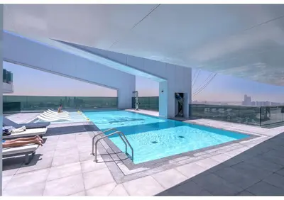 a swimming pool on the roof of a building at Luxury 2BR Close to Sheikh Zayed Rd, Prime Location, Burj View Opposite Metro in Dubai