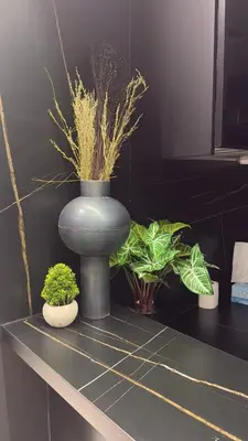 a blue vase sitting on a counter with plants at Luxury 2BR Close to Sheikh Zayed Rd, Prime Location, Burj View Opposite Metro in Dubai