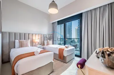 a hotel room with two beds and a large window at Splendid 2BR Apartment at Act One Act Two Tower 2 in Downtown Dubai by Deluxe Holiday Homes in Dubai