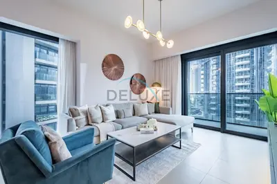 a living room with a couch and a table at Splendid 2BR Apartment at Act One Act Two Tower 2 in Downtown Dubai by Deluxe Holiday Homes in Dubai