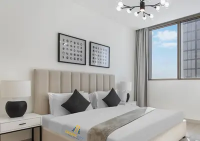 a bedroom with a large bed and a window at Fully Furnished 2 Bed in Sobha Creek Vista Reserve, Hosted by Desert City Stays in Dubai